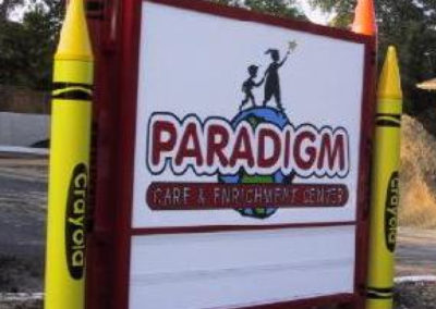 Paradigm Ground Sign with Fabricated Aluminum Crayons and Sign Cabinet – Michigan